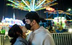 Faith Vang of East St. Paul kissed boyfriend Jayson Sanchez of Richfield as they waited to ride the Sky Flyer at the Minnesota State Fair’s Mighty M