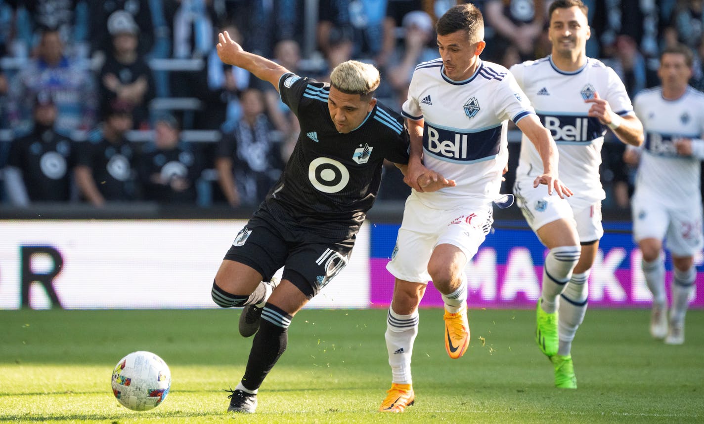 Minnesota United midfielder Emanuel Reynoso (10) pursued the ball as he was held by Vancouver Whitecaps midfielder Andrés Cubas (20) in the first half of their game Sunday afternoon, October 9, 2022 at Allianz Field in St. Paul. The Minnesota United FC shut out the Vancouver Whitecaps FC 2-0 in a Decision Day game. ] JEFF WHEELER • Jeff.Wheeler@startribune.com