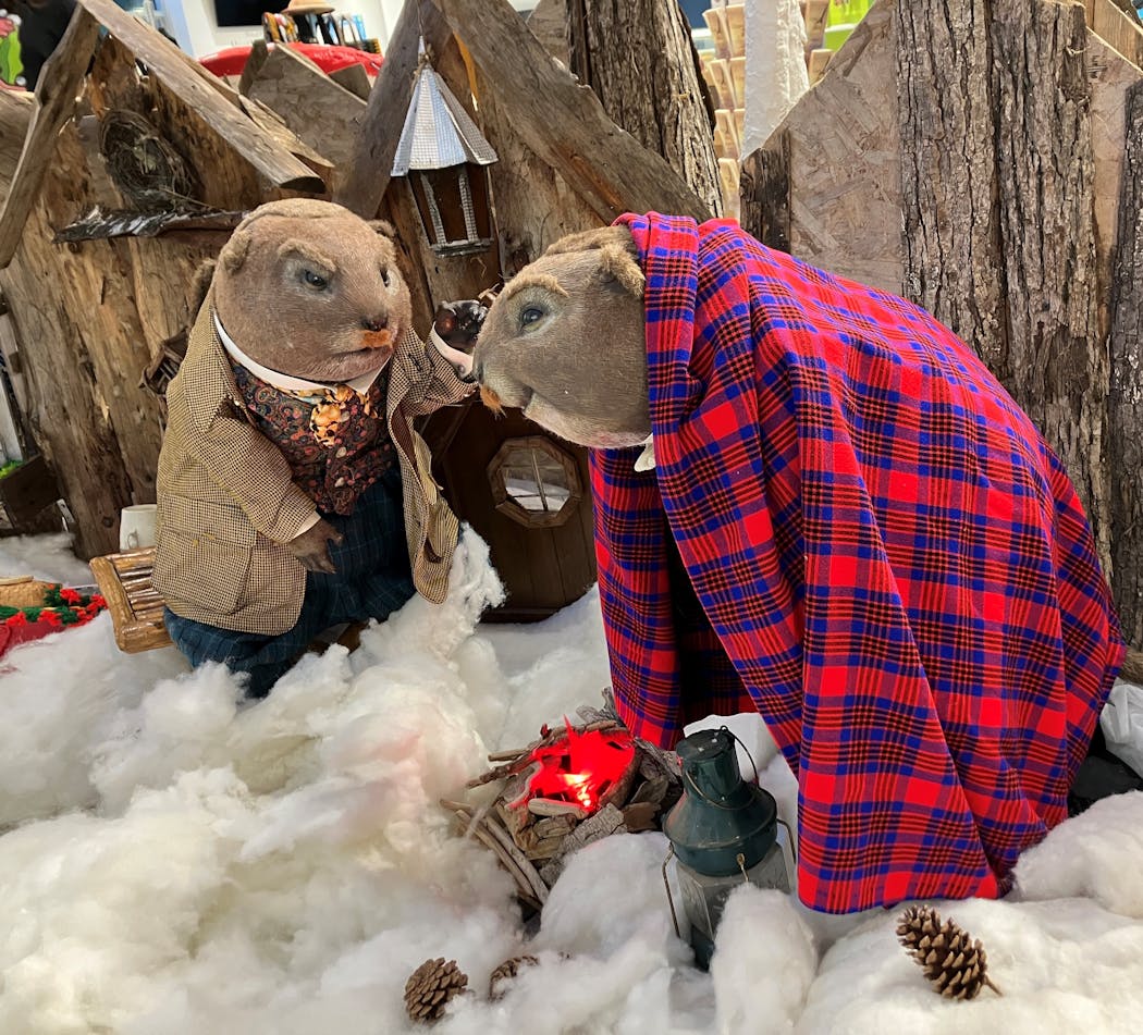 Jerry Carlson and his son, Cyrus, used their wooden elf houses as a backdrop for an ice-fishing scene depicting Ratty and Mole from “Wind in the Willows.”