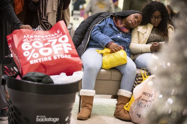 Shoppers take a break while shopping at the Mall of America on Black Friday.