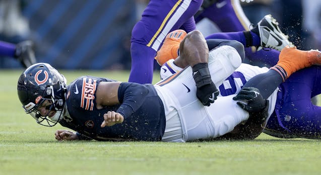 Bears quarterback Justin Fields suffered a hand injury on this sack by the Vikings’ Danielle Hunter in the third quarter.