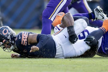 Bears quarterback Justin Fields suffered a hand injury on this sack by the Vikings’ Danielle Hunter in the third quarter.