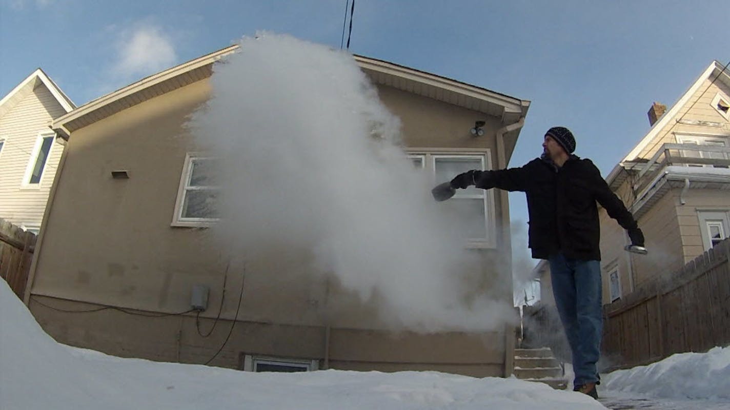 Nathan Ziegler throws boiling water in the cold air as part of his Minnesota Cold YouTube series.