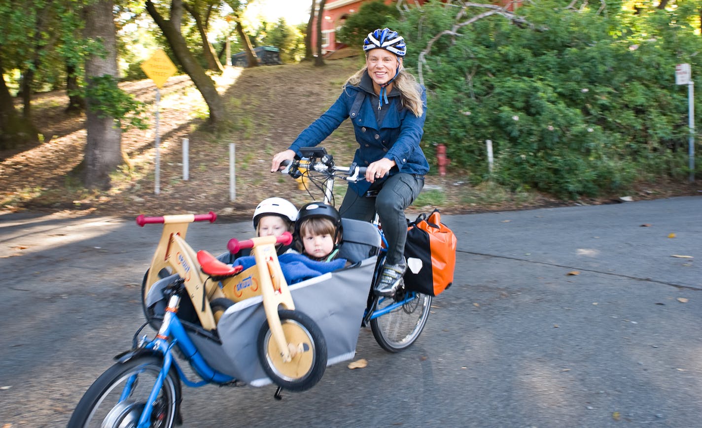 In this image from the documentary "Motherload," California filmaker Liz Canning rides a cargo bike with her two children. The film will be screened in Minnapolis on Oct. 24, 2019.