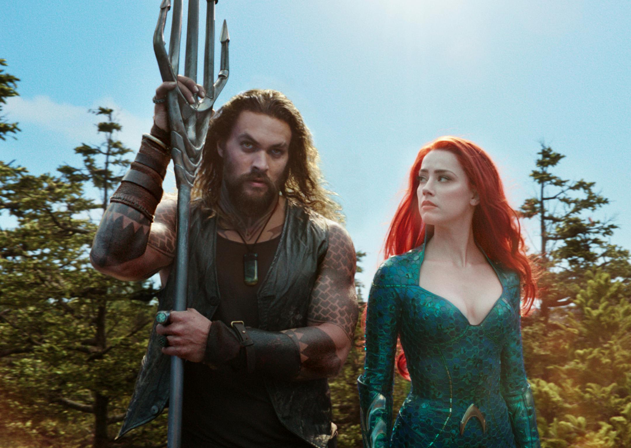 This image released by Warner Bros. Pictures shows Jason Momoa, left, and Amber Heard in a scene from "Aquaman." (Warner Bros. Pictures via AP)