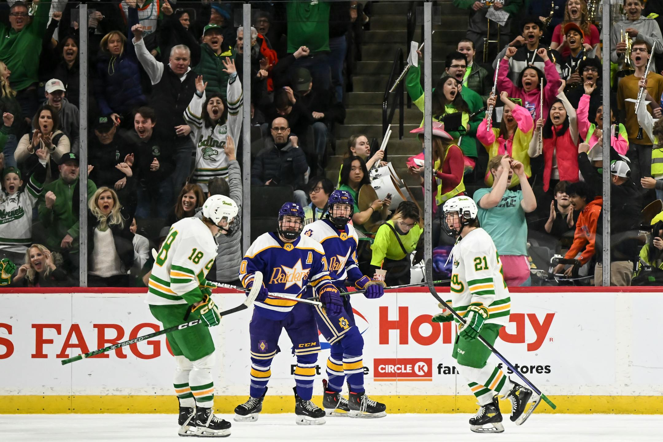 Edina forward Jackson Nevers (18) and forward Bobby Cowan (21) celebrate a goal by Cowan against Cretin-Derham Hall during the first period.