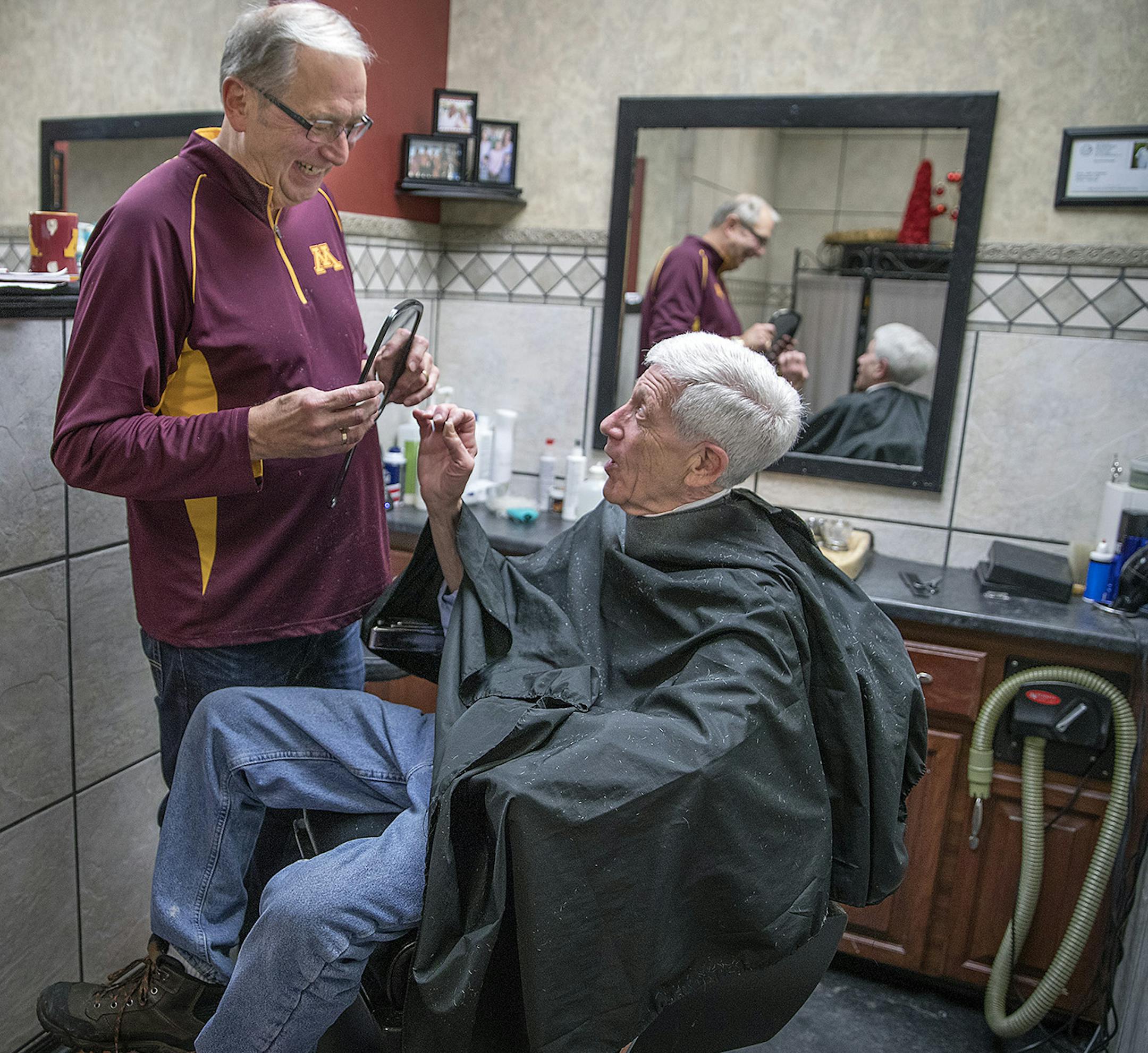 Barber John Vreeman gave long-time client Bill Rosenblom a peek at his new and last haircut by Vreeman at Crossing Skyway Barbers in The Crossings building, Thursday, January 25, 2018 in downtown Minneapolis, MN. ] ELIZABETH FLORES ï liz.flores@startribune.com