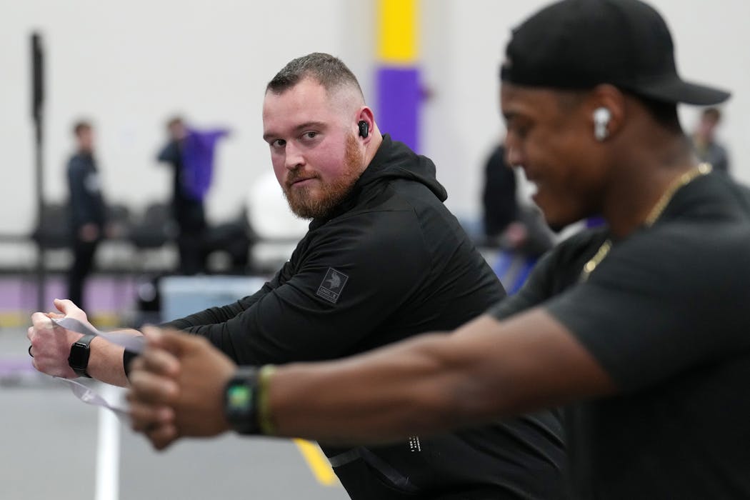 Vikings offensive guard Chris Reed (left) and fullback C.J. Ham (right) warmed up before the track and field competition at Minnesota State-Mankato last month.