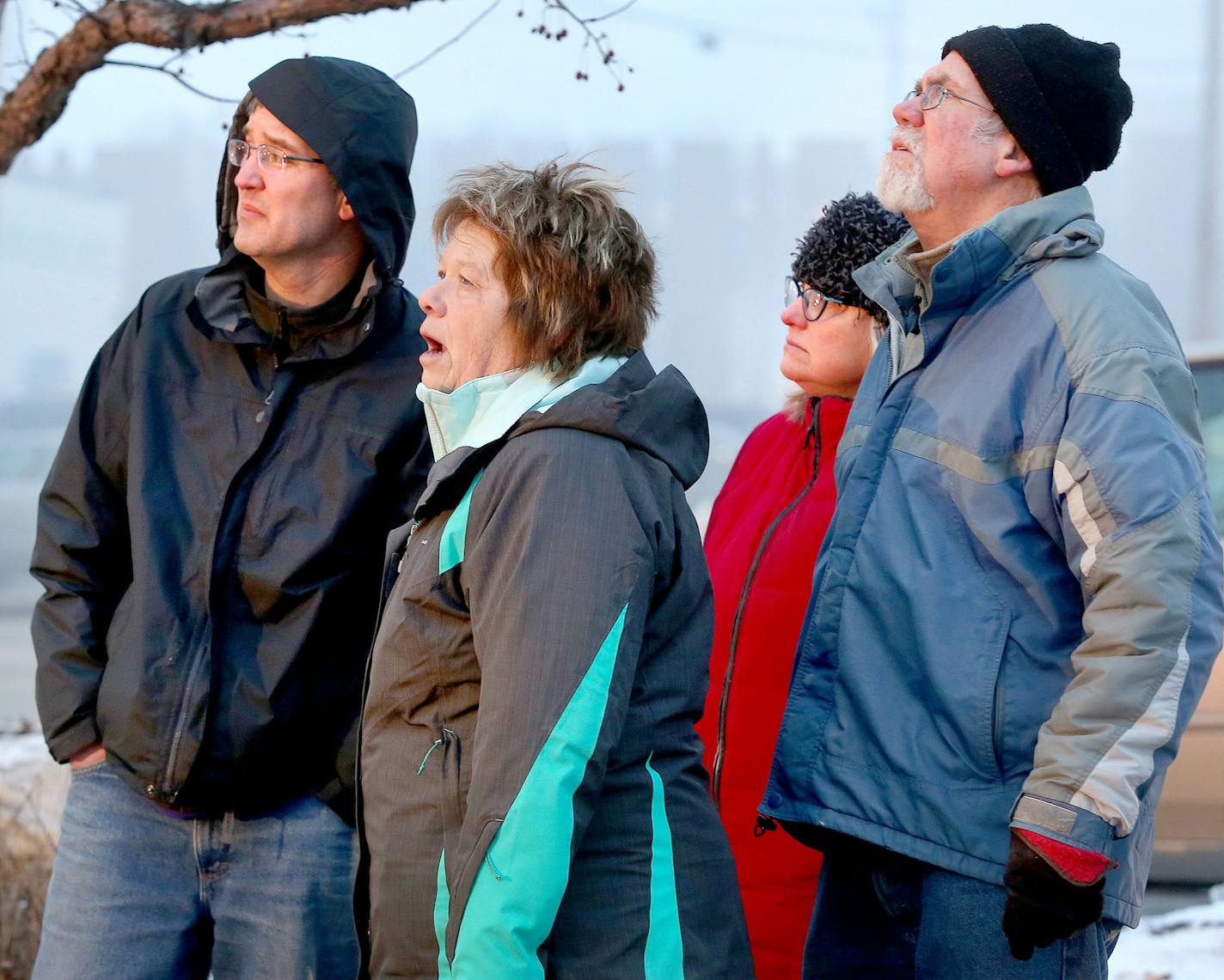 t2.18.16 Bob King -- kingCHURCHFIRE0219c6 -- Pastor David Carlson of Gloria Dei Lutheran Church (left), Karen Kjolhaug of the church staff (center) and others watch as fire crews work to put out a large fire at the church Thursday morning. "It's such a tragedy," said Carlson. Bob King / rking@duluthnews.com