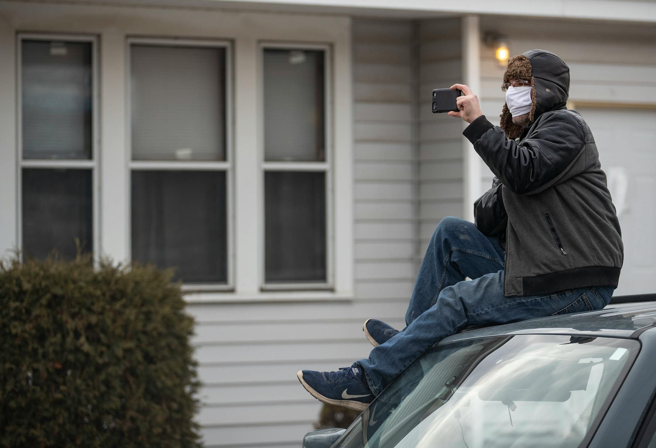 Local neighbors tried to get a look at the scene outside as St. Louis County sheriffs worked to assemble a grenade launcher to send non-lethal smoke grenades into the suspect's home.
