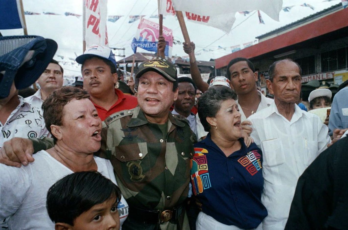 FILE - In this May 2, 1989 file photo, Gen. Manuel Antonio Noriega walks with supporters in the Chorrilo neighborhood, where he dedicated a new housing project, in Panama City. A source close to the family of former Panamanian dictator Manuel Noriega said Monday, May 29, 2017, that he has died at age 83.