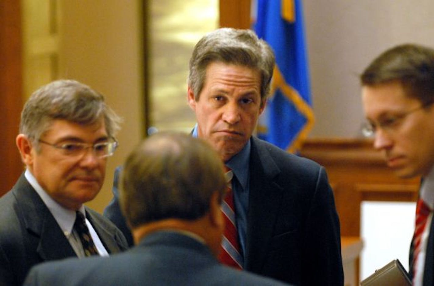 Republican Norm Coleman, center rear, meets with his attorneys, from left Tony Trimble, Joe Friedberg and Matt Haapoja during a break in Minnesota's U.S. Senate vote recount trial in St. Paul.