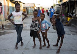 Children poses for a picture in the middle of the street in the Cite Soleil slum of Port-au-Prince, Haiti, Wednesday Dec. 27, 2017. Cite Soleil is an 