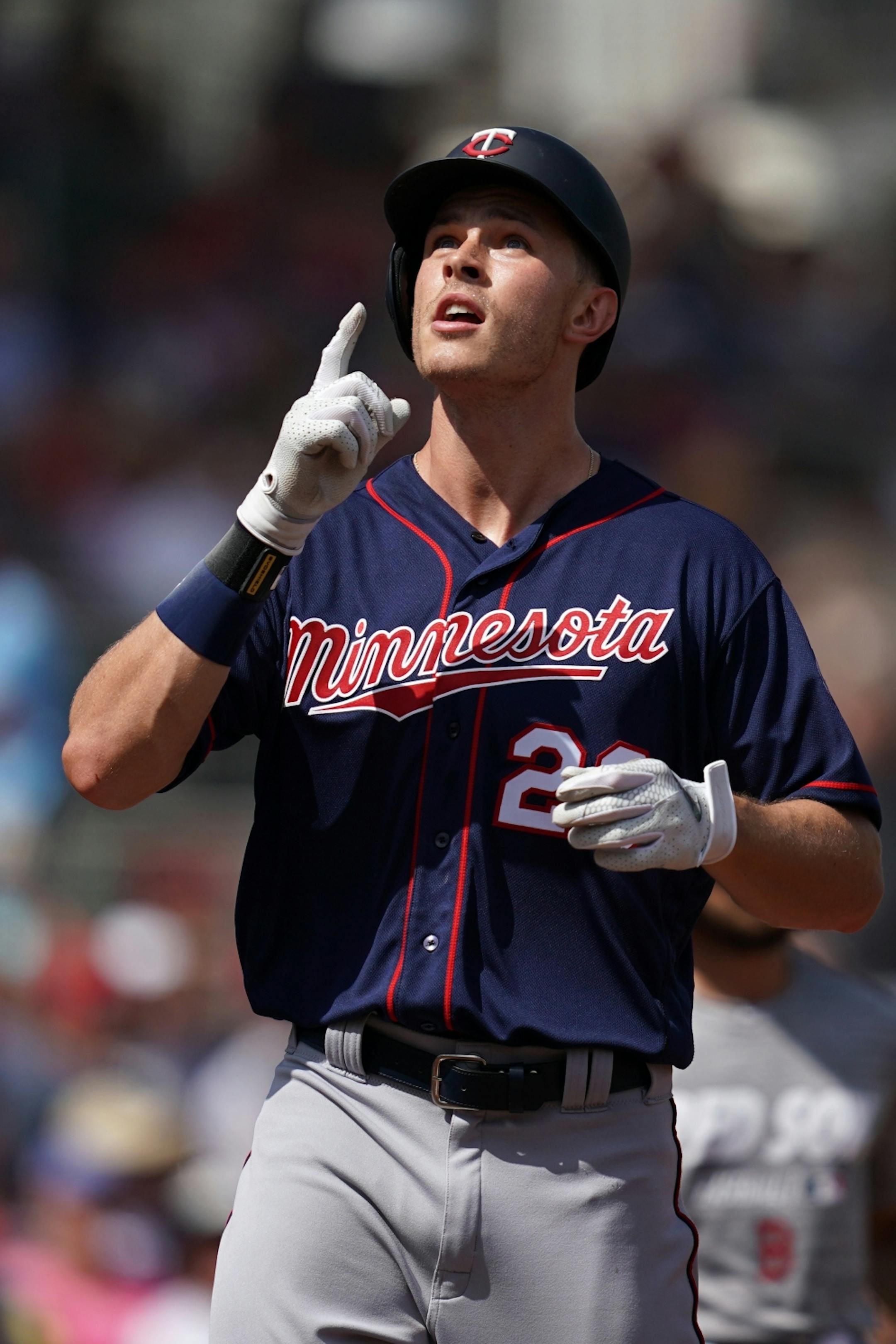 Minnesota Twins right fielder Max Kepler (26) pointed to the sky as he touched home plate after hitting a home run in his first at bat during Sunday's game.