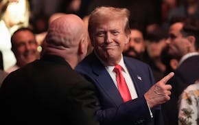 Former President Donald Trump, center right, talks to Dana White while attending the UFC 302 mixed martial arts event Saturday, June 1, 2024, in Newar
