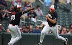 Minnesota Twins third base coach/outfield coach Tommy Watkins (40) waves Minnesota Twins first baseman Alex Kirilloff (19) in to score in the 4th inni