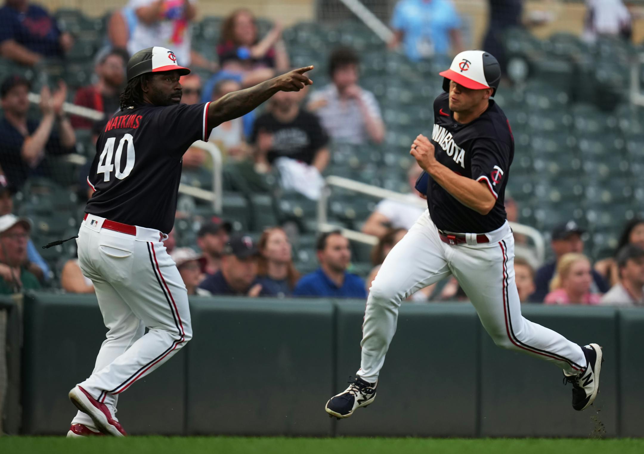 Minnesota Twins third base coach/outfield coach Tommy Watkins (40) waves Minnesota Twins first baseman Alex Kirilloff (19) in to score in the 4th inning in Minneapolis, Minn., on Thursday, June 1, 2023. The Twins take on the Cleveland Guardians at Target Field RICHARD TSONG-TAATARII • richard.tsong-taatarii @startribune.com