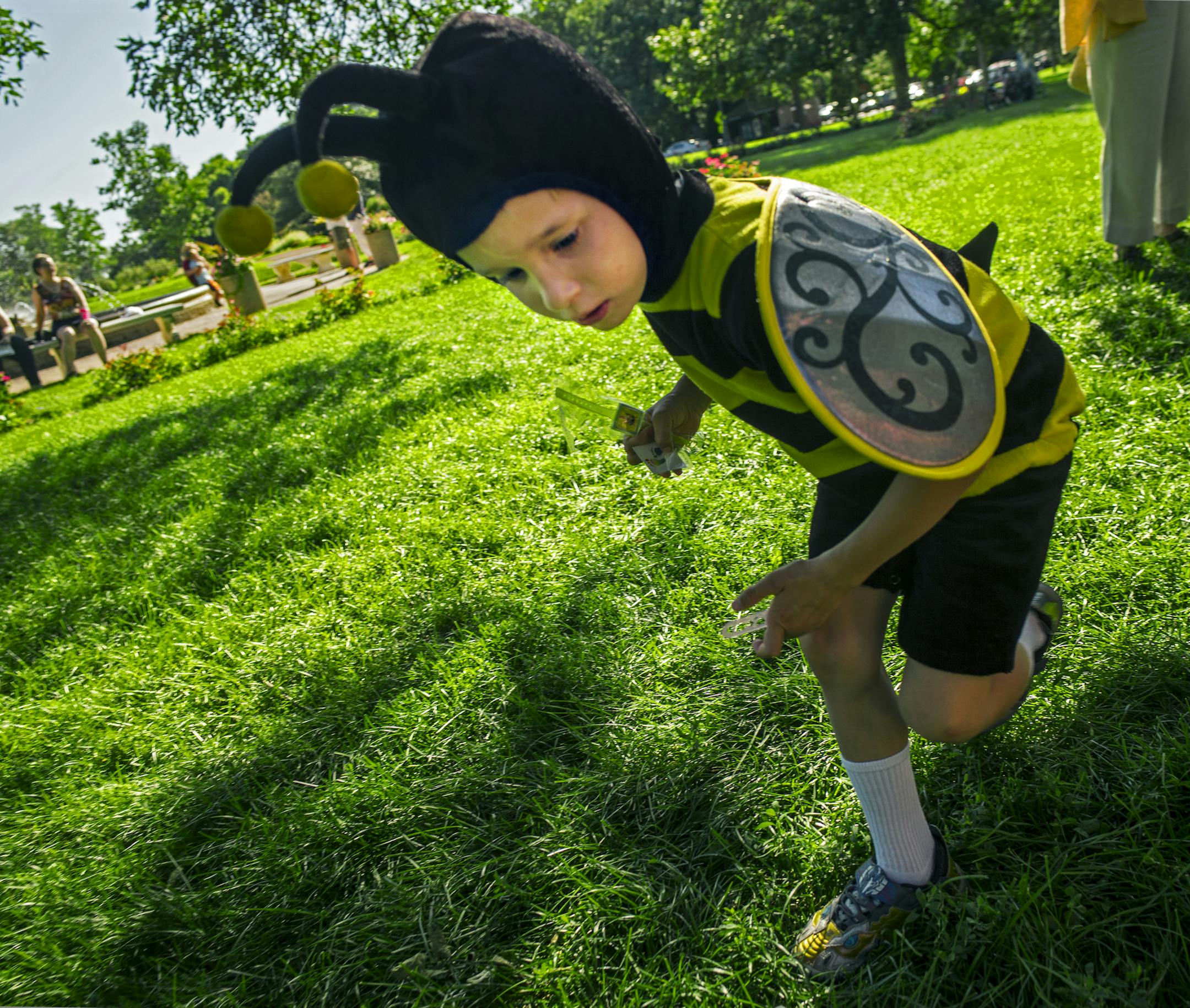 Bergen Dankey,5, buzzed about after picking up some candy from a bee hive pinada. His parents are part-time honey producers with 150 hives in the metro area. He likes to help with "smoking" the bees and pulling honey frames. "Pollinator Party: a Celebration of Bees" was held across from the Peace Garden in Minneapolis, .] Richard Tsong-Taatarii/rtsong-taatarii@startribune.com