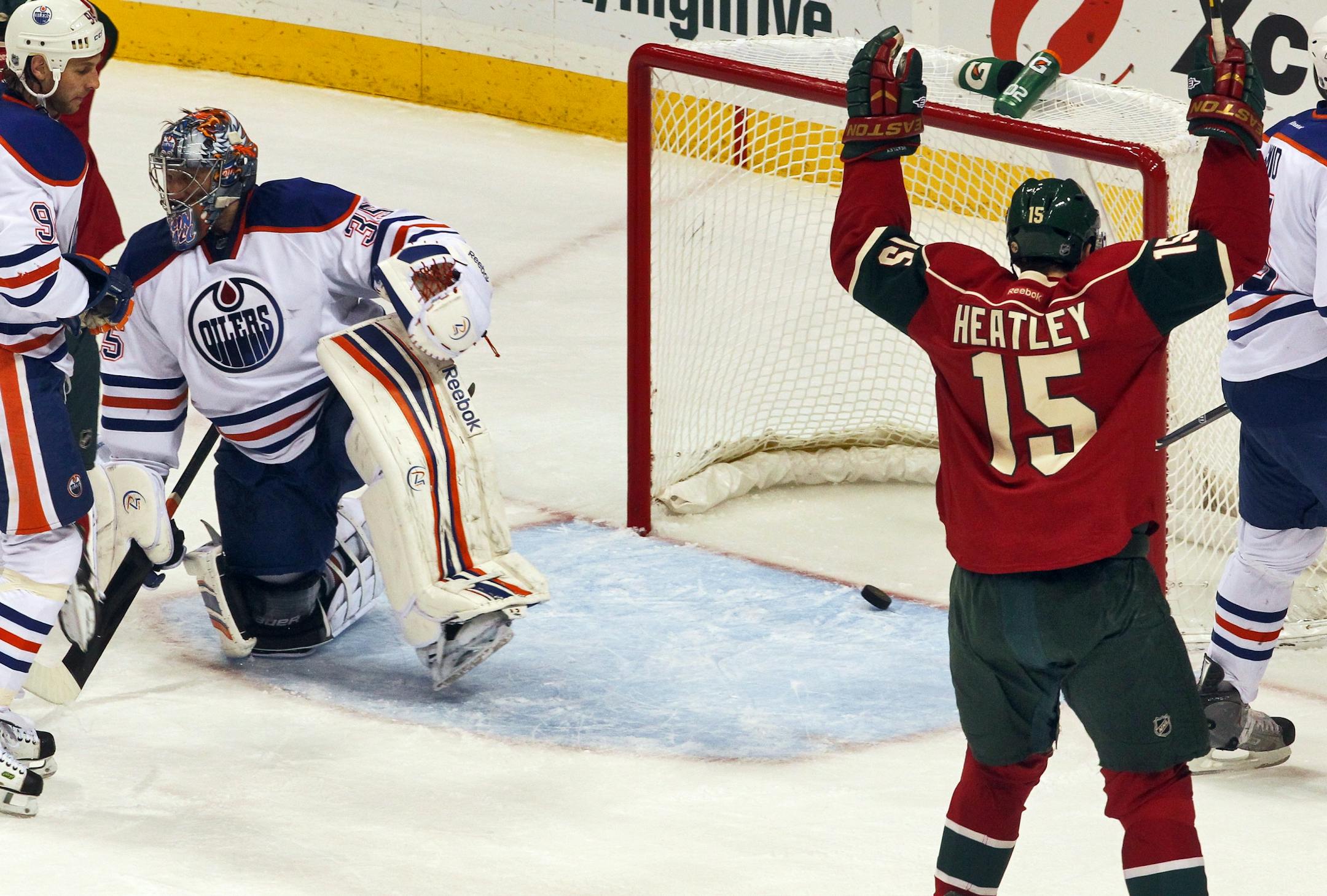 Dany Heatley (15) was ready to high-five after Mikko Koivu scored the Wild's first goal, beating Oilers goalie Nikolai Khabibulin.