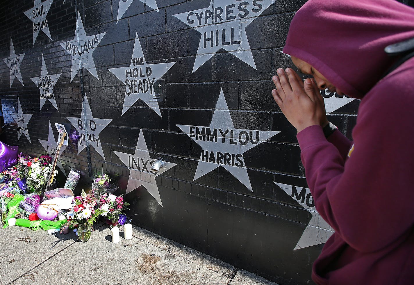 Terrance May, also known as "May Millions" prayed near Prince's star at First Avenue after news of his death was made, Thursday, April 21, 2016 in Minneapolis, MN.