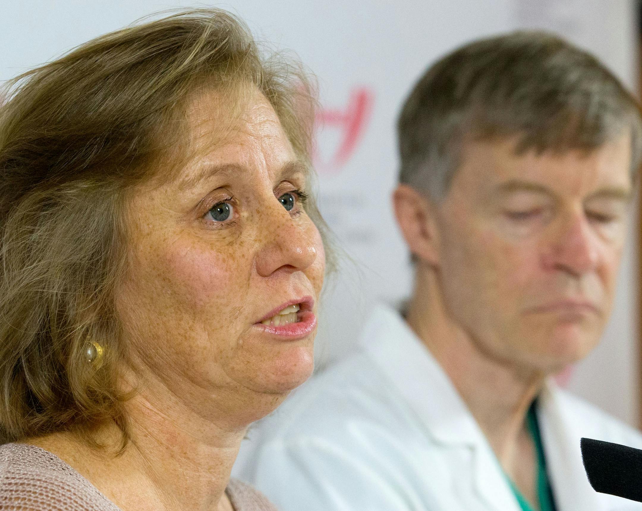 Debbie Sacra, the wife of the Ebola patient being treated at the University of Nebraska Medical Center, Dr. Rick Sacra, meets with the local media for the first time Thursday, Sept. 11, 2014. Dr Philip Smith, the medical director of the Nebraska Biocontainment ... of infectious diseases at the University of Nebraska Medical Center is at right. (AP Photo/The World-Herald, James R. Burnett)