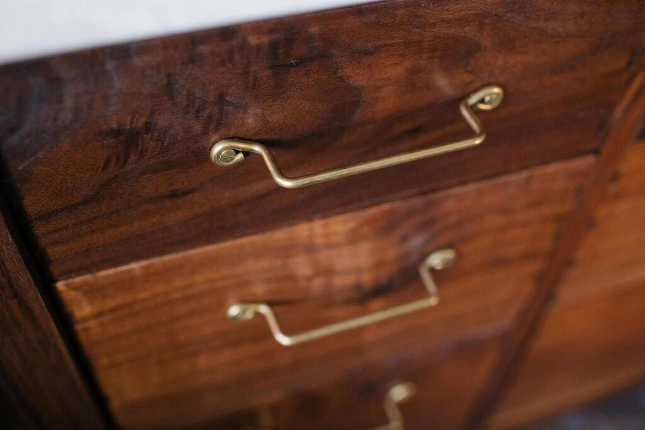 Handmade wire pulls of antique brass on the vanity.