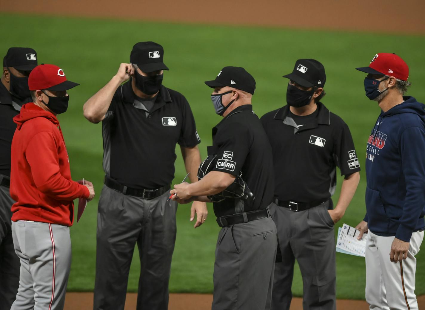 Reds manager David Bell, brother to Twins bench coach Mike Bell, spoke to umpires and exchanged lineup cards before the first pitch of a game in September.