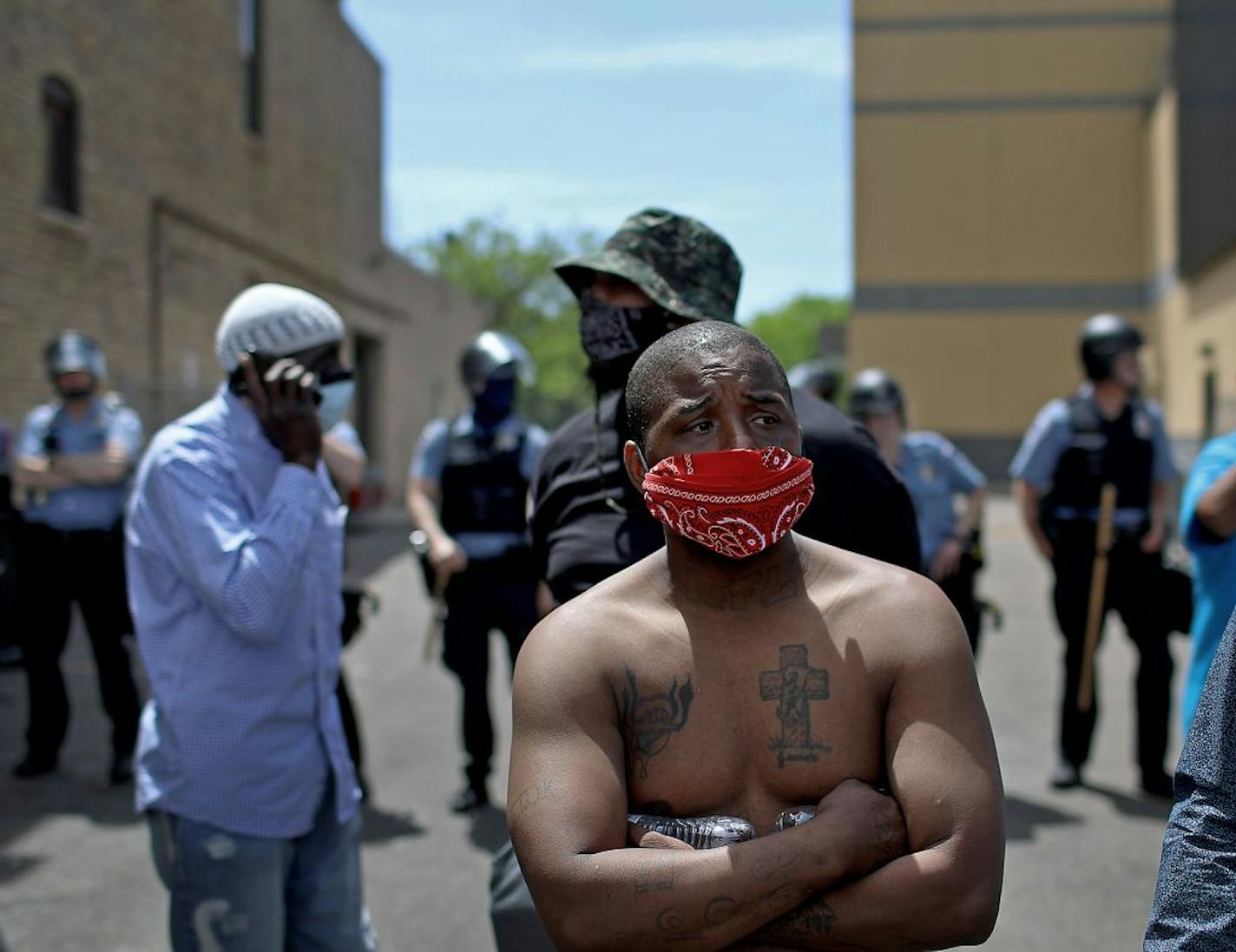 Edward Washington of Minneapolis acts as a buffer between Minneapolis police and protestors outside the Minneapolis Police Third Precinct as protestors stood nearby Thursday, May 28, 2020, in Minneapolis, MN. Washington said it was important to protect members of the community, including children.