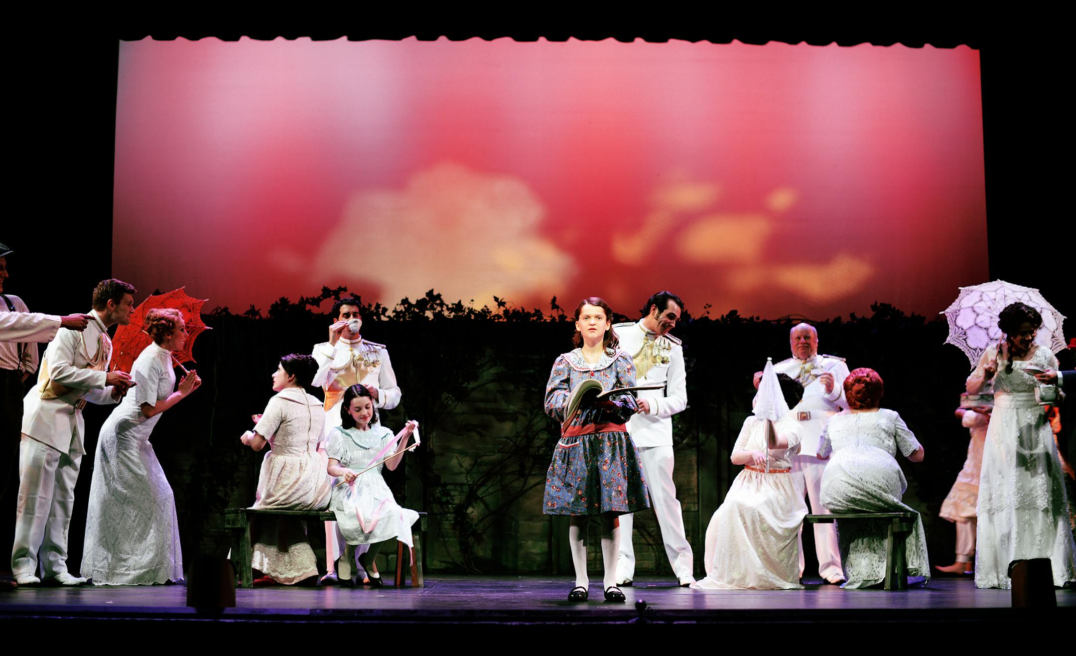 Caitlyn Carroll as Mary, center, in Artistry’s production of “The Secret Garden.”
