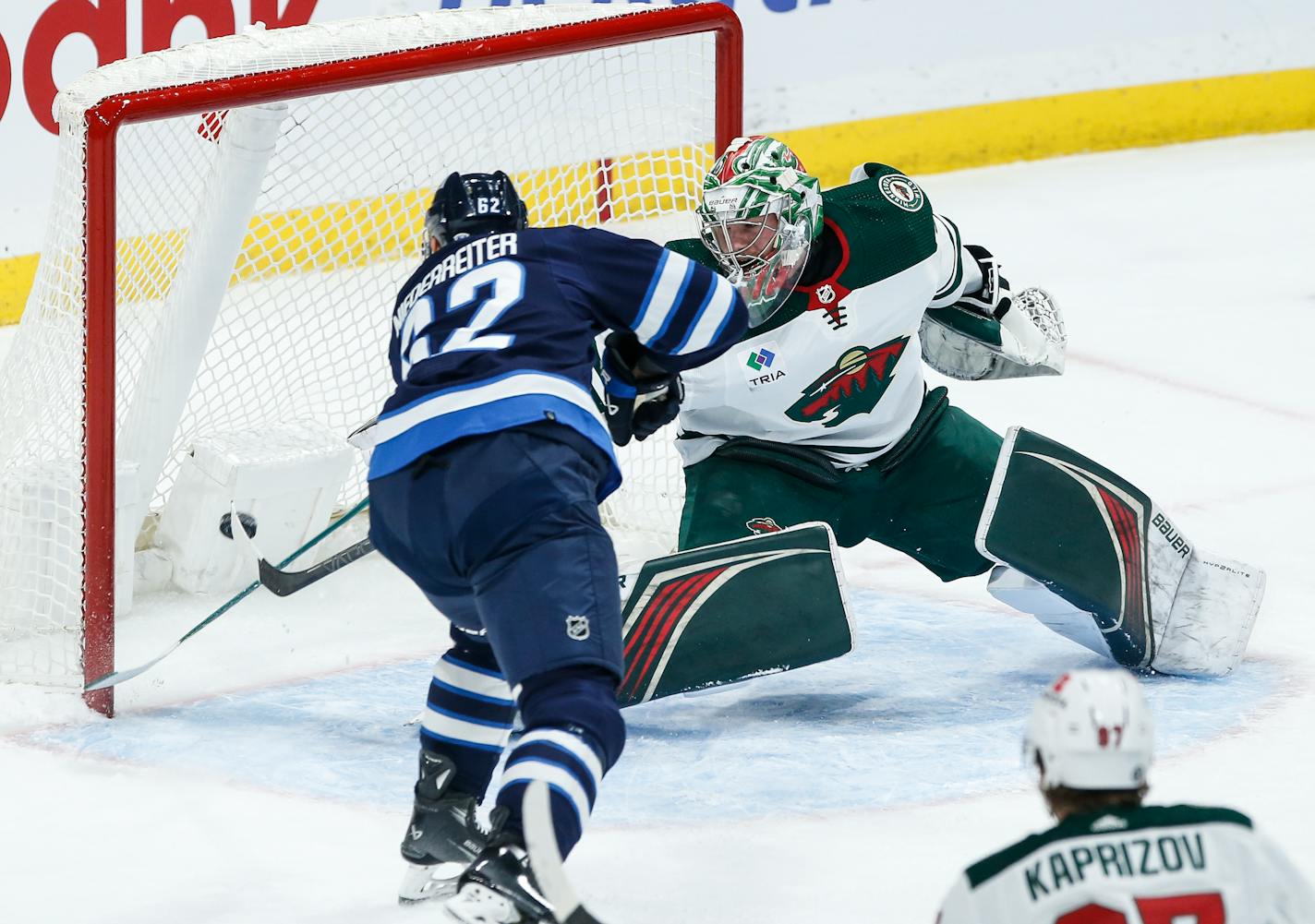 Winnipeg Jets' Nino Niederreiter (62) scores against Minnesota Wild goaltender Filip Gustavsson (32) during the first period of an NHL hockey game, Saturday, Dec. 30, 2023 in Winnipeg, Manitoba. (John Woods/The Canadian Press via AP)