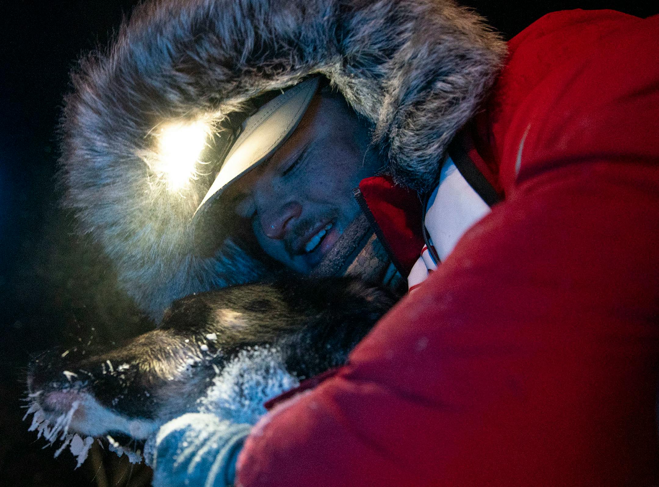 Ero Wallin pet one of his sled dogs after finishing the John Beargrease sled dog marathon in Grand Portage, Minn. on February 2, 2021. Ero finished in sixth place.
