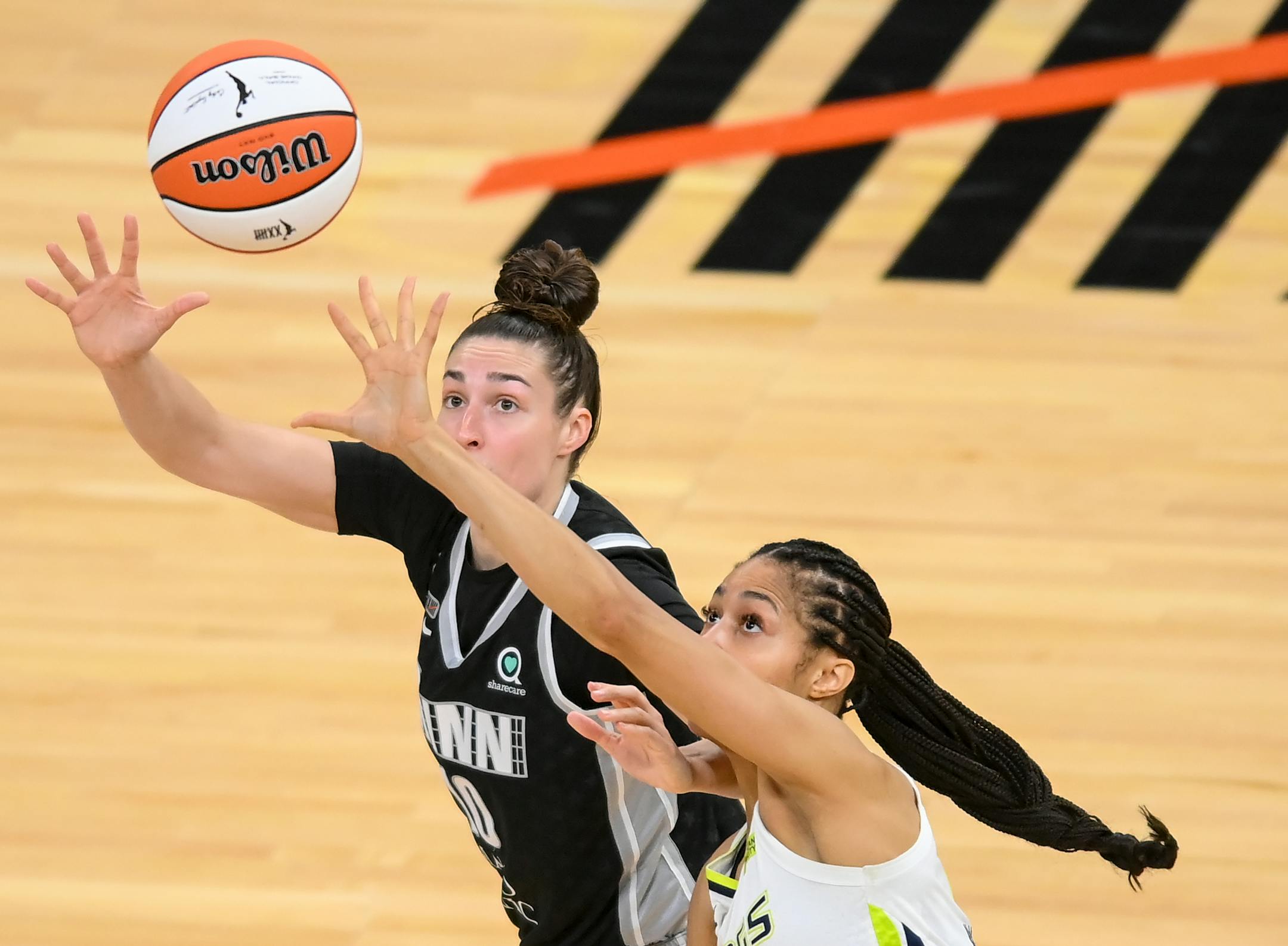 Dallas Wings forward Isabelle Harrison (20) knocked the ball loose from Minnesota Lynx forward Jessica Shepard (10) before scoring a basket in the first half.