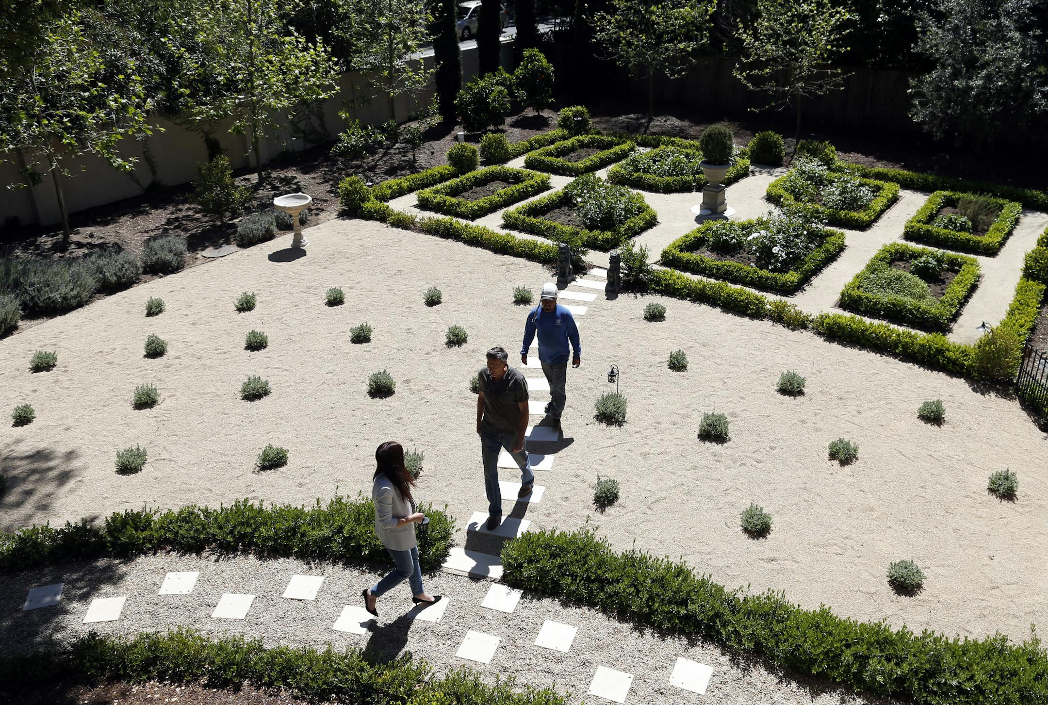 Designer Jules Nolet, lower left, walks through the drought-resistant garden she installed on the large, acre-plus property she owns in Atherton, Calif., on Tuesday, April 14, 2015. (Karl Mondon/Bay Area News Group/TNS) ORG XMIT: 1166944