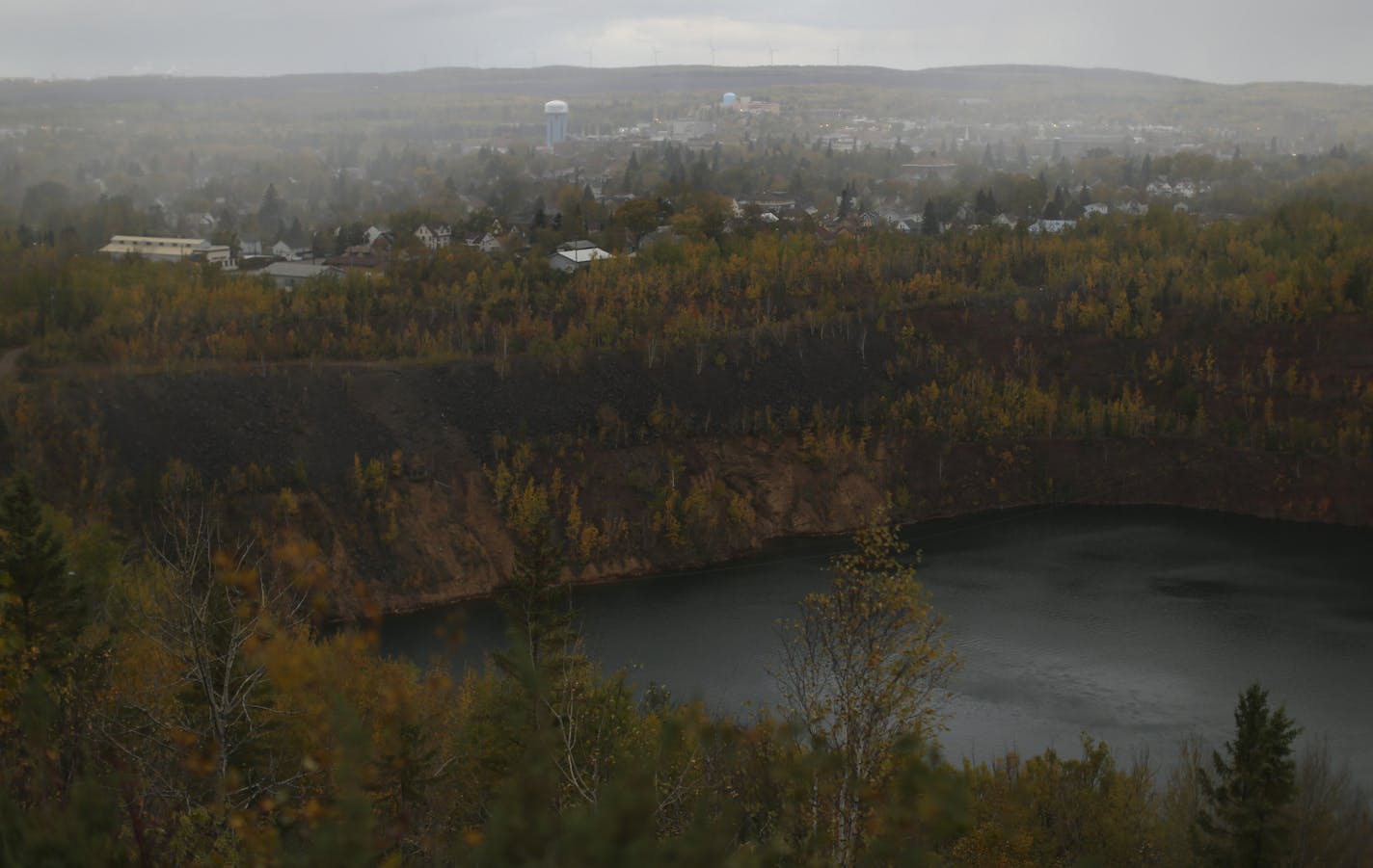 A snow squall passed over Virginia Tuesday afternoon. Two of the Highway 53 relocation scenarios call for building a bridge over the former mine known as the Rocheleau Pit in the foreground. ] JEFF WHEELER &#x2022; jeff.wheeler@startribune.com A four-lane stretch of highway through the Iron Range is about to vanish into an open pit mine and the state only has a few years left to figure out where, and how, to build a new route for Highway 53. Eveleth would have been isolated if the cheapest plan