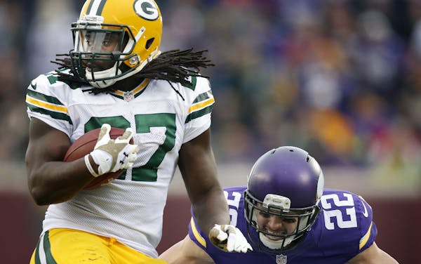 Packers running back Eddie Lacy (27) attempted to spin away from Chad Greenway (52) in the third quarter. Green Bay beat Minnesota by a final score of