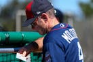 Minnesota Twins manager Paul Molitor (4) referenced his roster during live batting practice Monday.