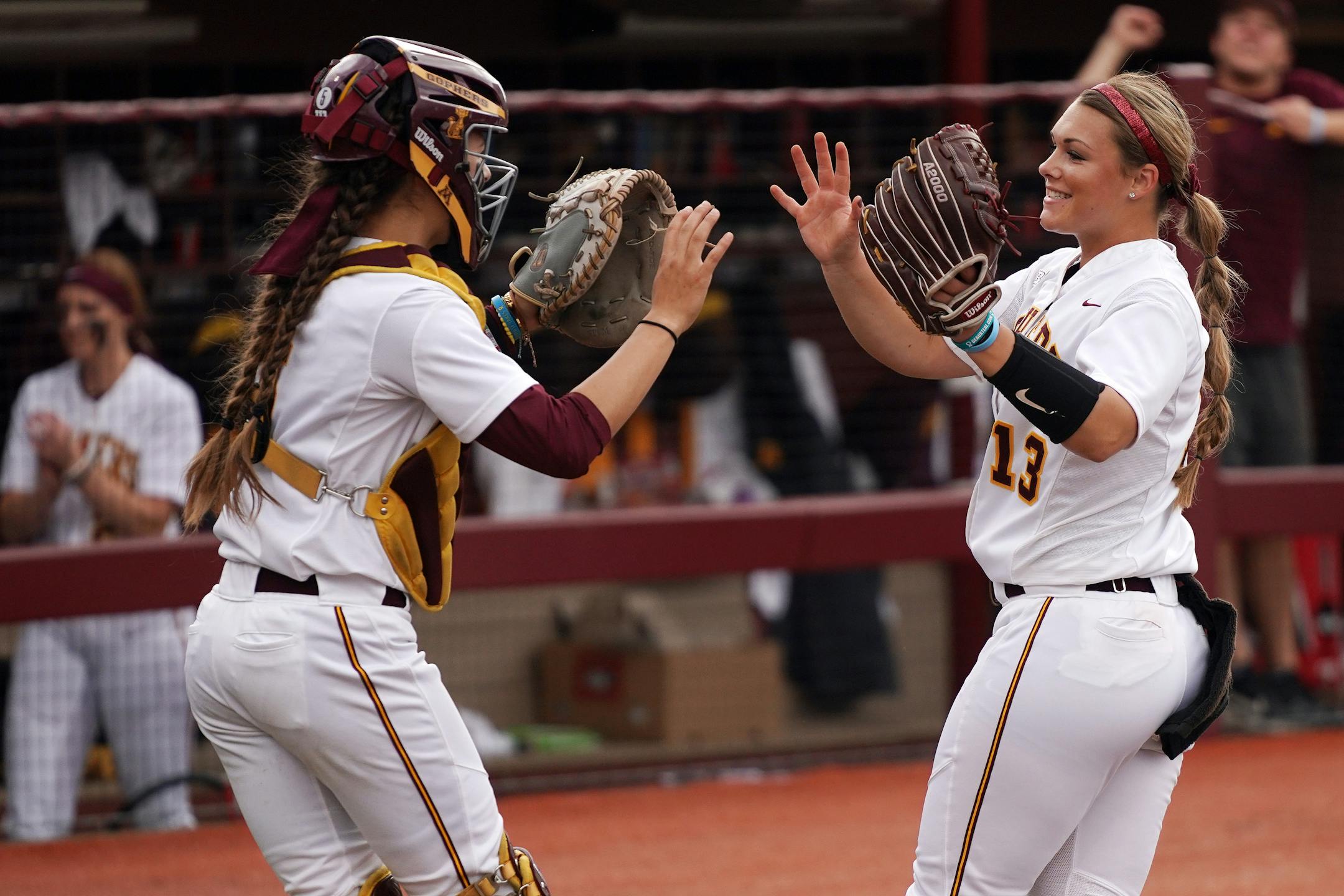 Gophers pitcher Amber Fiser (13) celebrated with catcher Emma Burns
