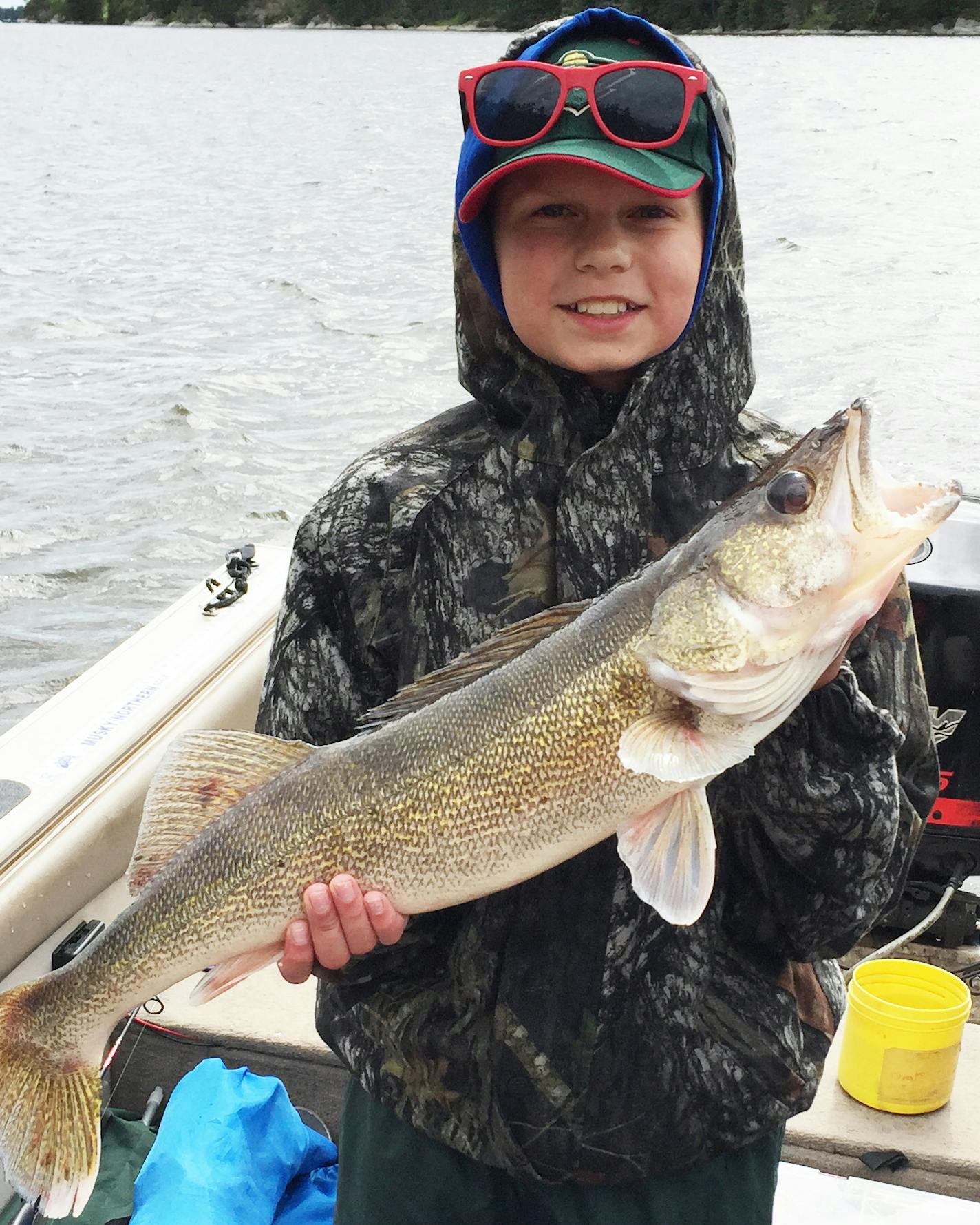 SOMETHING'S HAPPENING TJ Everson, 12, of Apple Valley caught and released this 28&#x2126; inch walleye on Lake of the Woods while trying to net his Grandpa&#xed;s northern pike. &#xec;Grandpa, I have something going on here, you&#xed;re going to have to take the net!&#xee; he said. The fish was TJ&#xed;s biggest walleye ever.