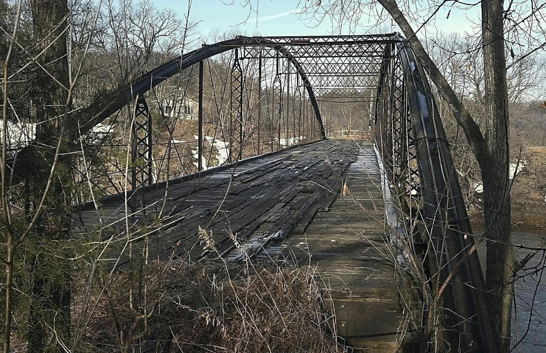 This March 26, 2019 photo, shows, The Kern Bridge south of Mankato, Minn., which is the longest of its type remaining in the United States. The bridge is tentatively scheduled to be dismantled this summer or fall after 146 years spanning the Le Sueur River. It will be put in storage until a new use as a pedestrian or bike bridge can be found. (Pat Christman/The Free Press via AP) ORG XMIT: MNMAN201