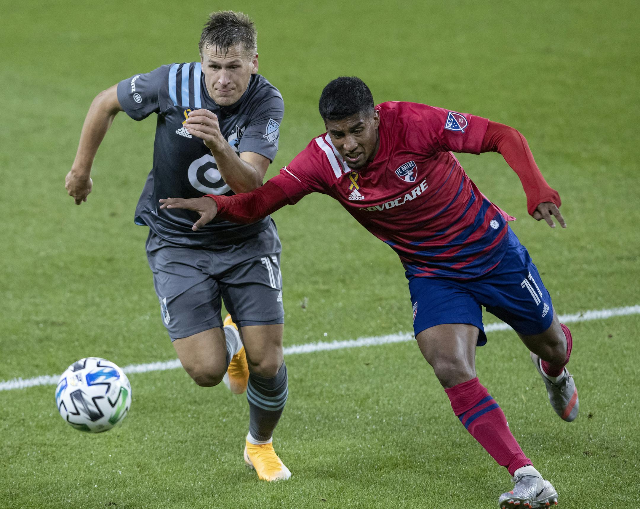 Minnesota United's Robin Lod, left, and FC Dallas' Andrés Ricaurte (11) vie for the ball during the second half of an MLS soccer match Wednesday, Sept. 9, 2020, in St. Paul, Minn. (Carlos Gonzalez/Star Tribune via AP)