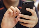 FILE - In this Friday, Sept. 16, 2017, file photo, a person uses a smart phone in Chicago. A new analysis suggests that increased social media use cou