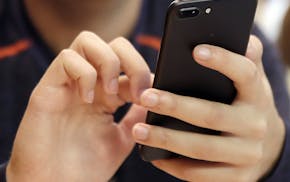 FILE - In this Friday, Sept. 16, 2017, file photo, a person uses a smart phone in Chicago. A new analysis suggests that increased social media use cou