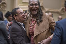 Andrea Jenkins got a hug from Rep. Keith Ellison after being sworn-in as a new council member for Ward 8 in the City Council Chambers, Tuesday, Januar