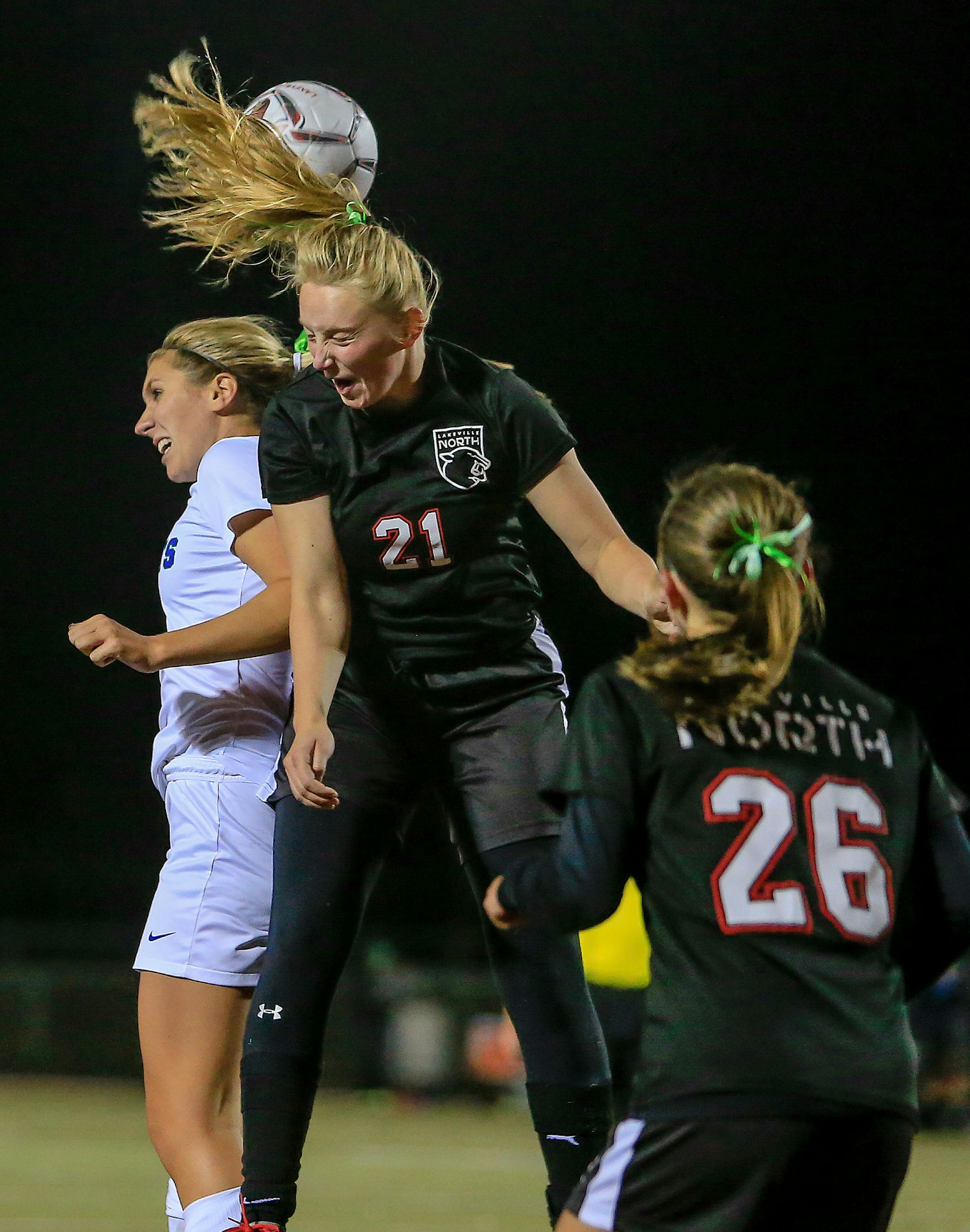Lakeville North junior Sydney Gelhorn (21) goes up for a header in a September 2018 game against Eagan. Photo by Mark Hvidsten, SportsEngine