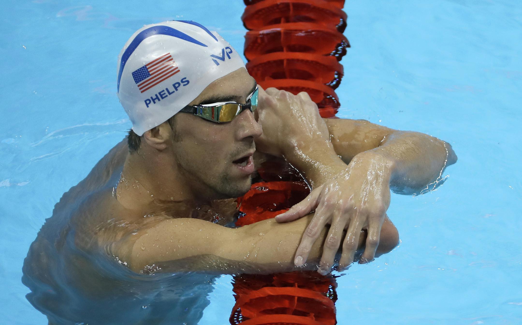 United States' Michael Phelps holds on a lane marker during a training session prior to the 2016 Summer Olympics in Rio de Janeiro, Brazil, Tuesday, Aug. 2, 2016. (AP Photo/Matt Slocum)