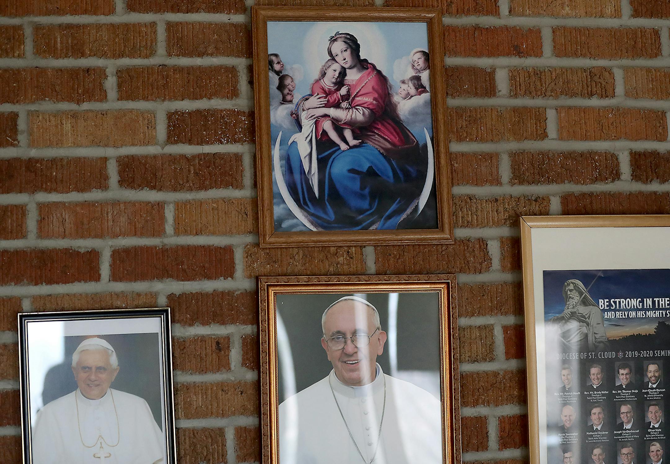 Photos of Pope Benedict XVI, left, and Pope Francis hang in the hallway outside of St. Clare's Monastery Chapel Thursday, April 16, 2020, in Sauk Rapids, MN. Poor Clare nuns of St. Clare's Monastery nuns met with journalists in the monastery's parlor, the one room where outsiders have partial access to the nuns in a room divided by a metal lattice with a folding wooden divider.