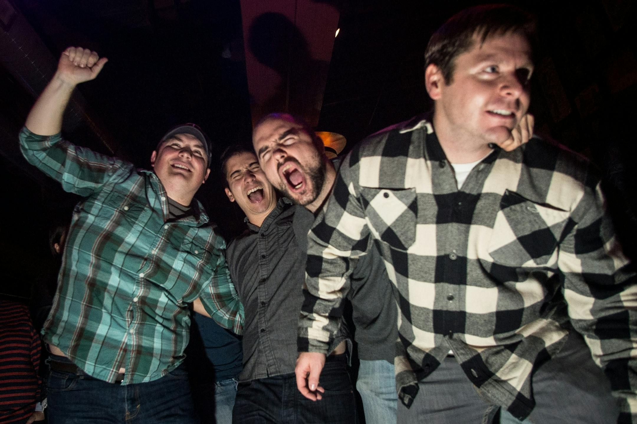 From left, Ed Pfeilsticker, Zan Lano, Carl Mickman and Nick Rudie dance to the music played by Appetite for Zaccardi early Saturday morning at Turf Club.