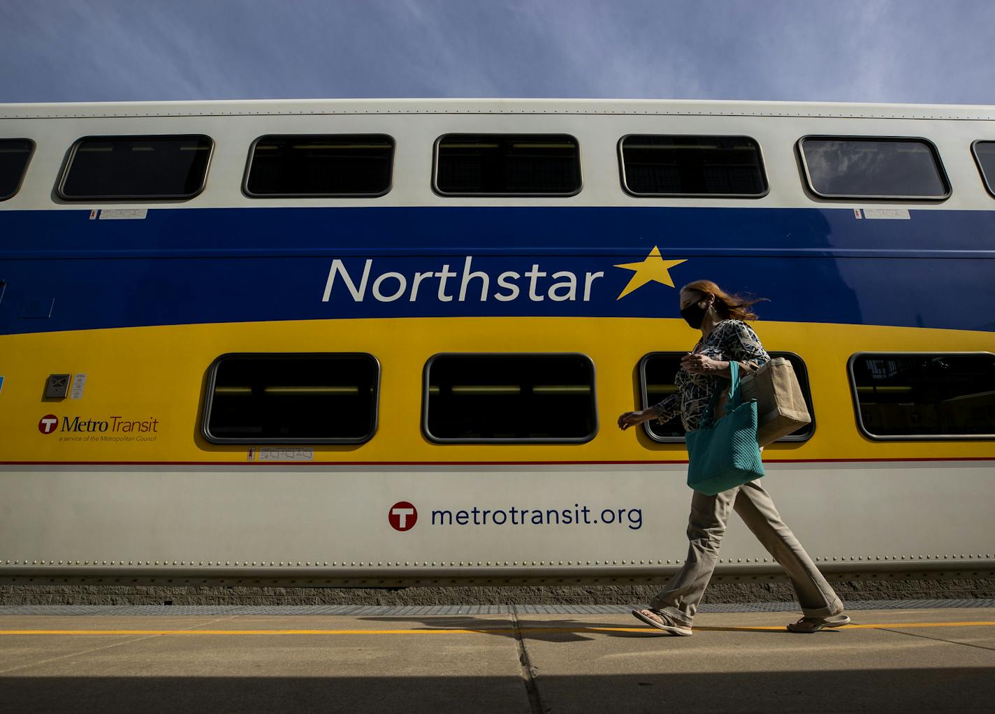 A passenger walked to board the last Northstar Commuter Rail train out of Minneapolis on Monday, Aug. 10.