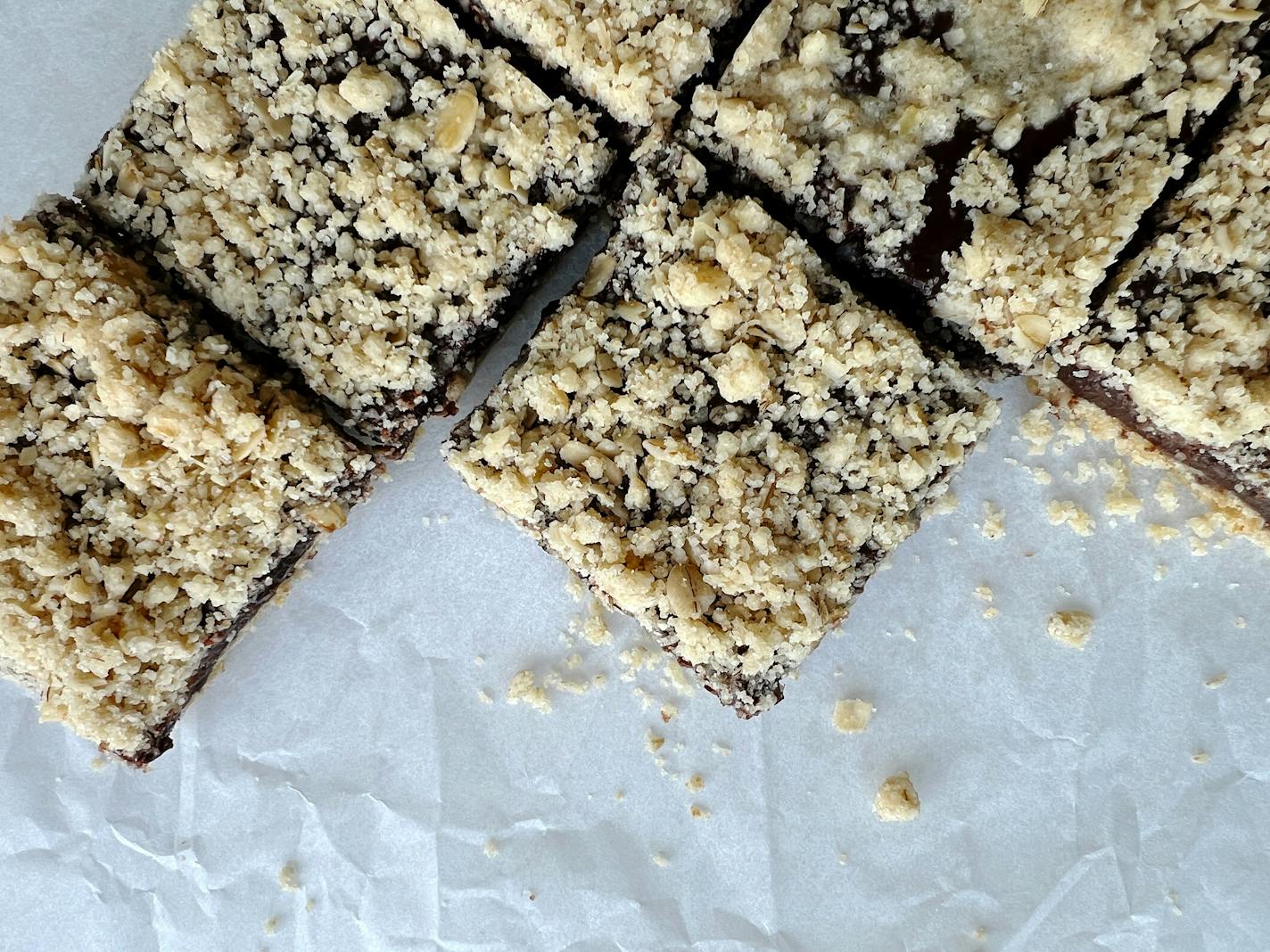 A pan of chocolate oat bars cut into squares to feed a crowd.