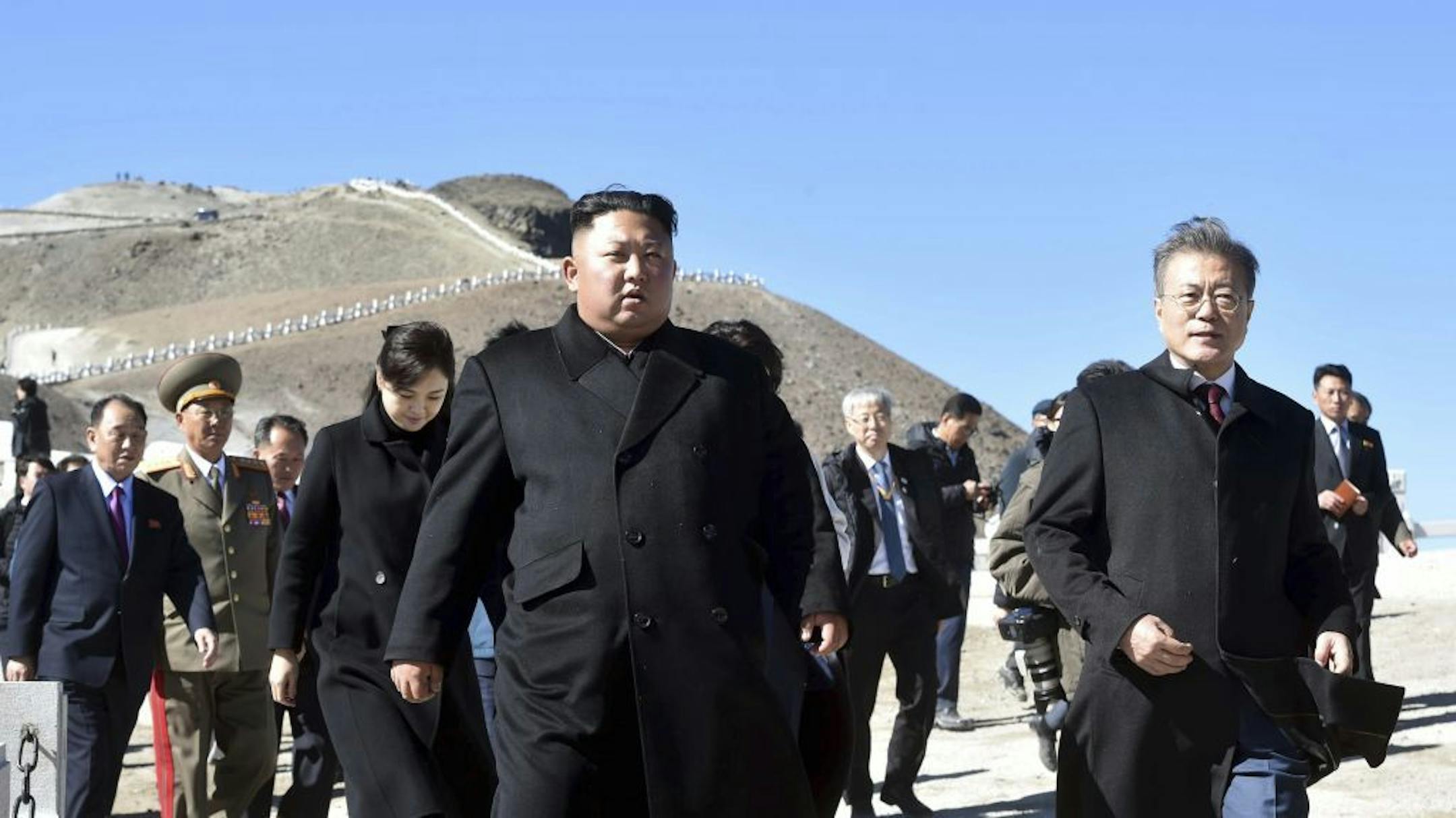 South Korean President Moon Jae-in, right, and North Korean leader Kim Jong Un, left, visit the Mount Paektu in North Korea, Thursday, Sept. 20, 2018. Moon and North Korean leader Kim Jong Un visited the picturesque and active volcano on the North Korean-Chinese border on Thursday and took a cable car to the crater lake called "Chonji" where they strolled together.